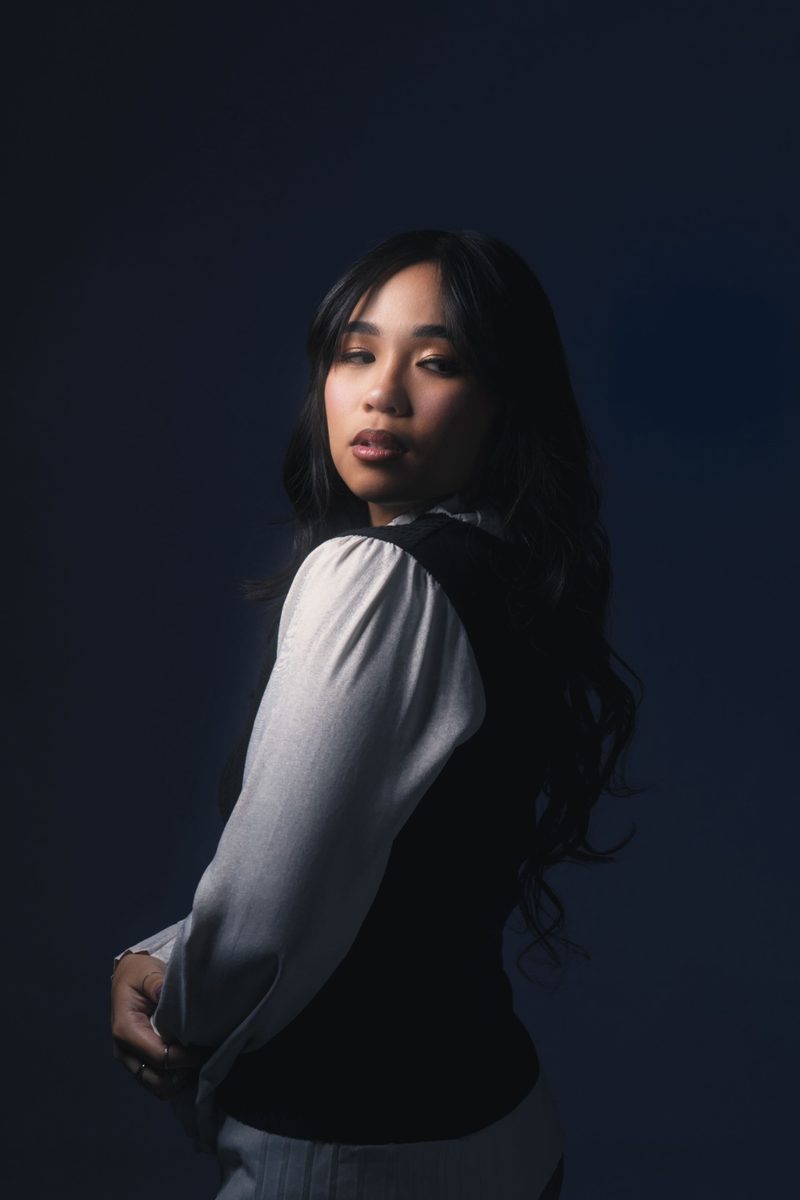 Flores looking over shoulder in blue light